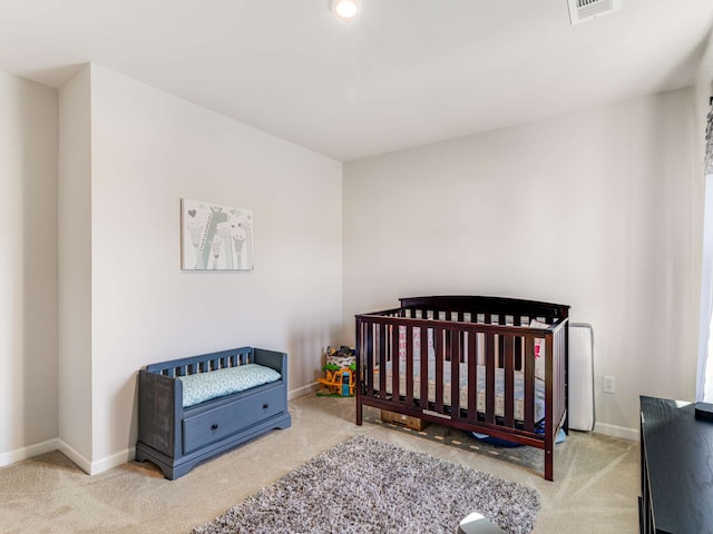 carpeted bedroom with a crib