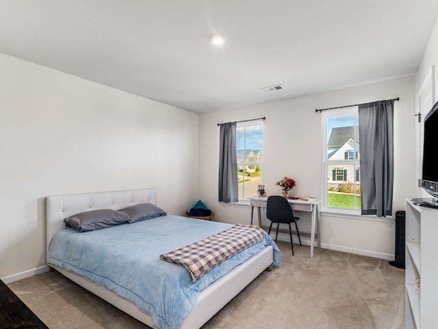 bedroom featuring light carpet