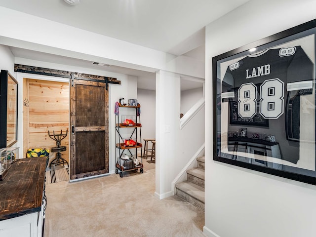 interior space featuring a barn door and carpet