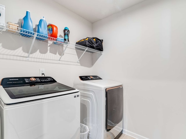 laundry room featuring washing machine and clothes dryer