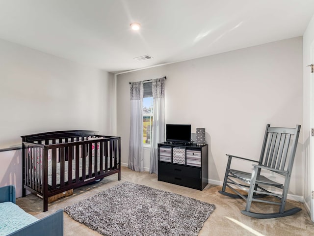 bedroom with carpet and a nursery area