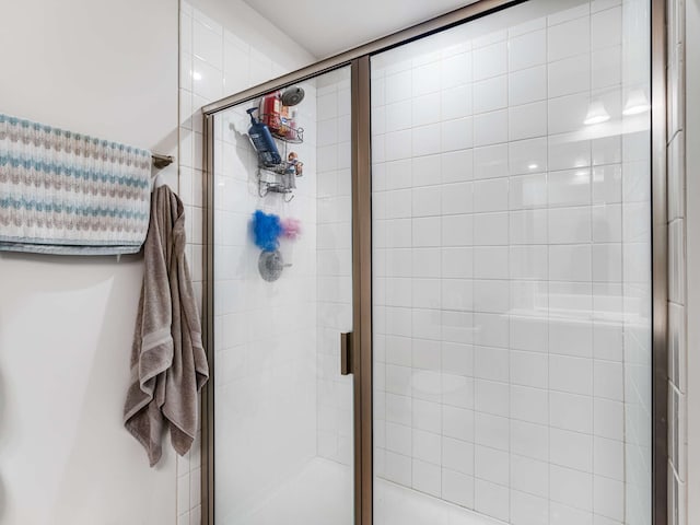 bathroom with a shower with shower door