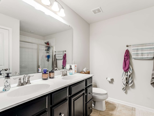 bathroom with vanity, a shower with shower door, tile patterned flooring, and toilet