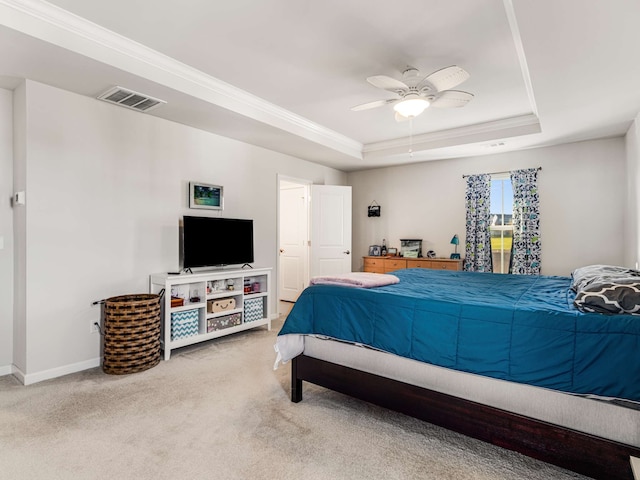 carpeted bedroom featuring ceiling fan and a raised ceiling