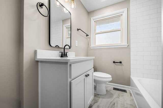 full bathroom with toilet, vanity, and tiled shower / bath