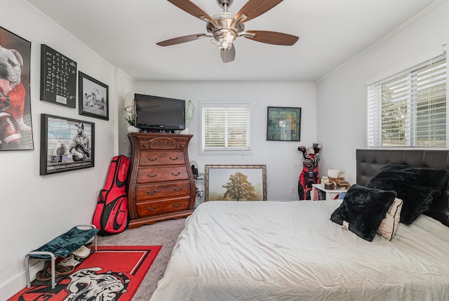 carpeted bedroom featuring ceiling fan and ornamental molding