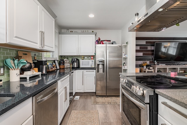 kitchen featuring light hardwood / wood-style floors, white cabinetry, stainless steel appliances, and exhaust hood