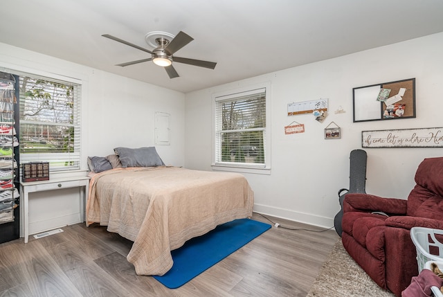 bedroom with ceiling fan and wood-type flooring