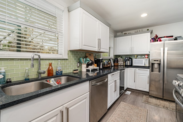 kitchen featuring white cabinets, stainless steel appliances, and sink