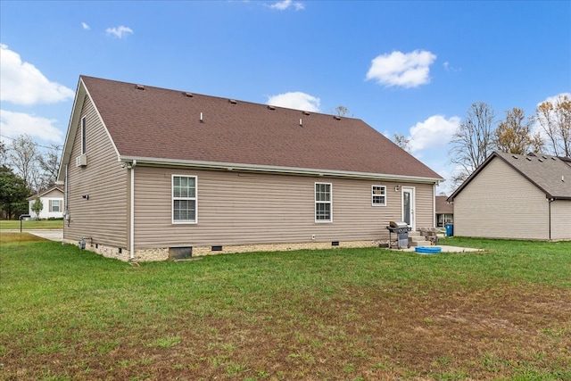 back of property with a patio area and a yard