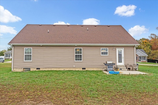 back of property with a patio area and a lawn