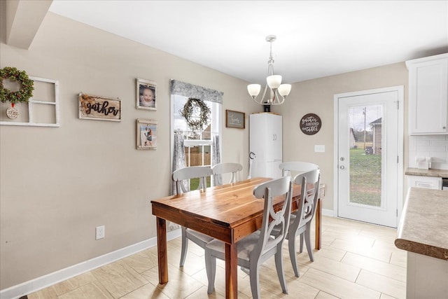 dining area featuring a healthy amount of sunlight and an inviting chandelier