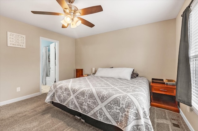 bedroom with carpet floors, ceiling fan, and connected bathroom