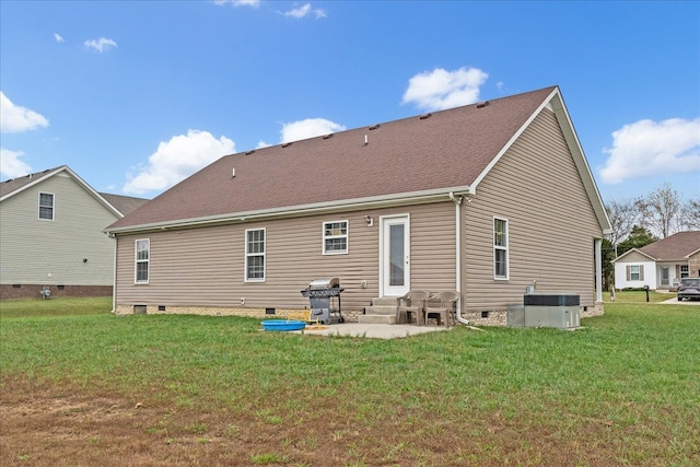 back of house featuring central AC unit, a lawn, and a patio