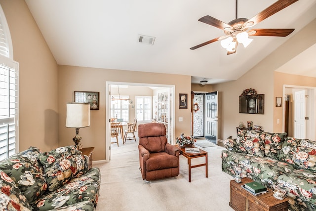 carpeted living room with lofted ceiling and ceiling fan