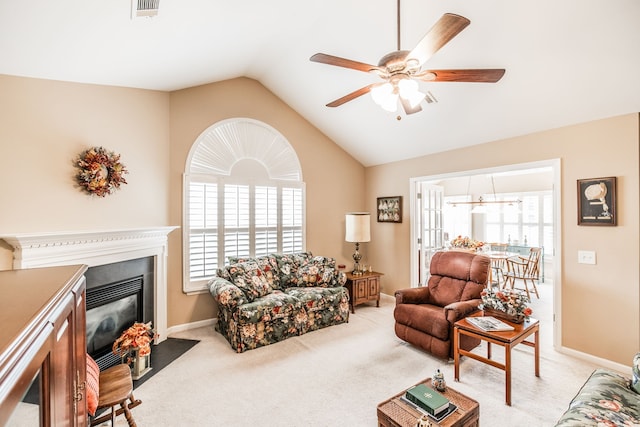 living room with ceiling fan, light carpet, and vaulted ceiling