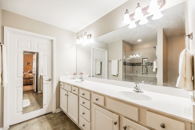 bathroom with tile patterned floors, vanity, and a shower with door