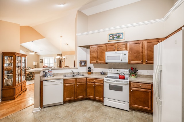 kitchen featuring sink, kitchen peninsula, ceiling fan with notable chandelier, high vaulted ceiling, and white appliances