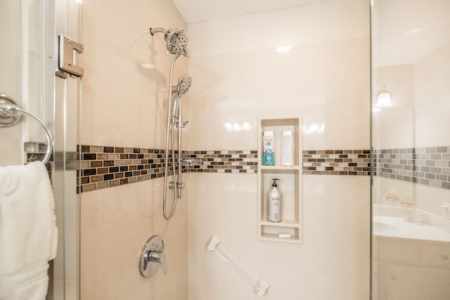 bathroom featuring tiled shower and tile walls