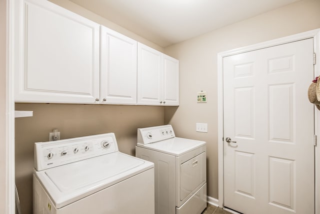 washroom with washing machine and dryer and cabinets