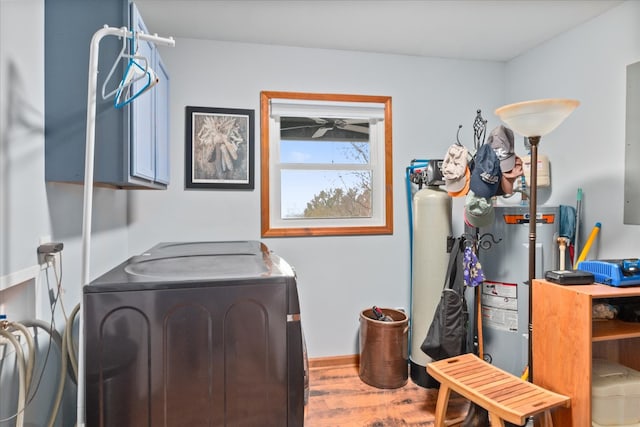 laundry room featuring separate washer and dryer, hardwood / wood-style floors, and gas water heater