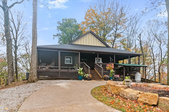 farmhouse inspired home with a porch and a sunroom