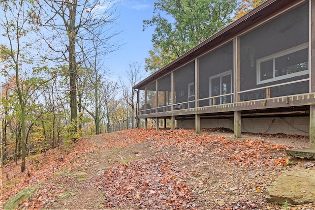 view of side of property featuring a sunroom