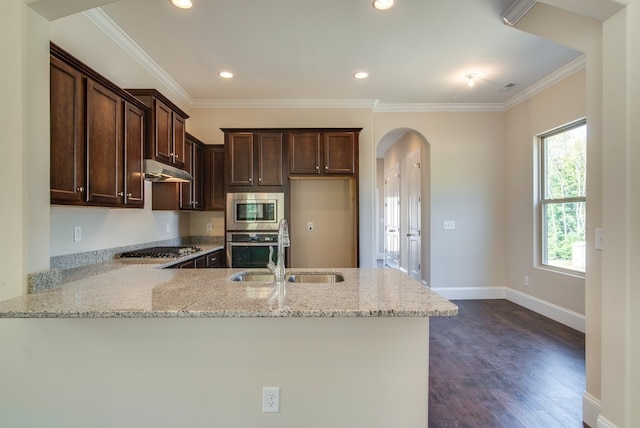 kitchen with stainless steel appliances, sink, kitchen peninsula, and light stone counters