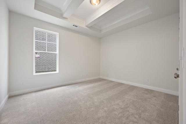 carpeted empty room featuring beamed ceiling