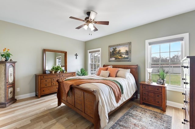 bedroom with ceiling fan and light hardwood / wood-style flooring