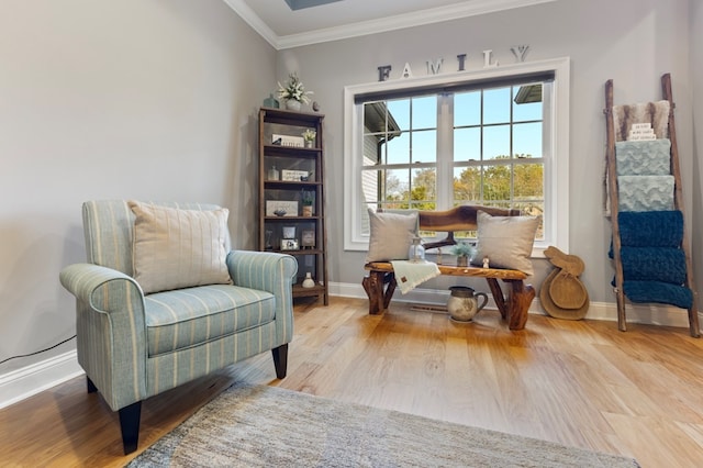 sitting room featuring light hardwood / wood-style flooring and ornamental molding