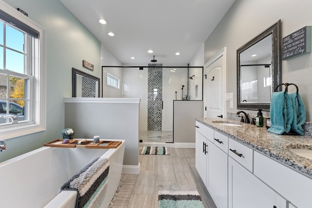 bathroom featuring vanity and shower with separate bathtub