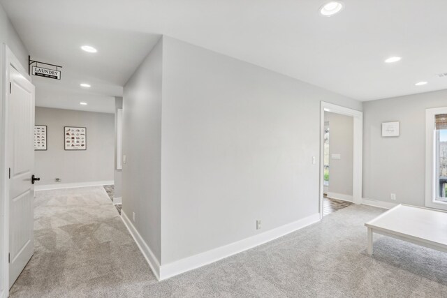 hallway featuring light carpet