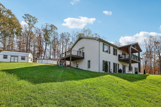 back of property with an outdoor structure and a yard