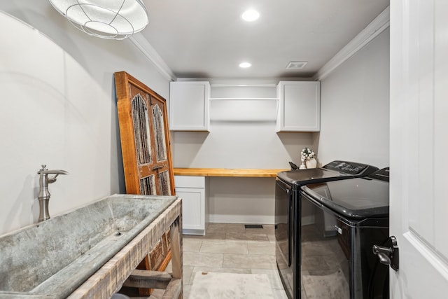 laundry area featuring cabinets, light tile patterned floors, washer and dryer, and ornamental molding