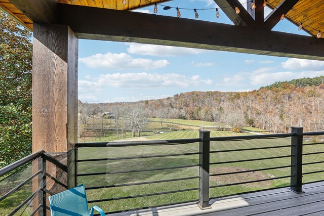 wooden terrace featuring a rural view