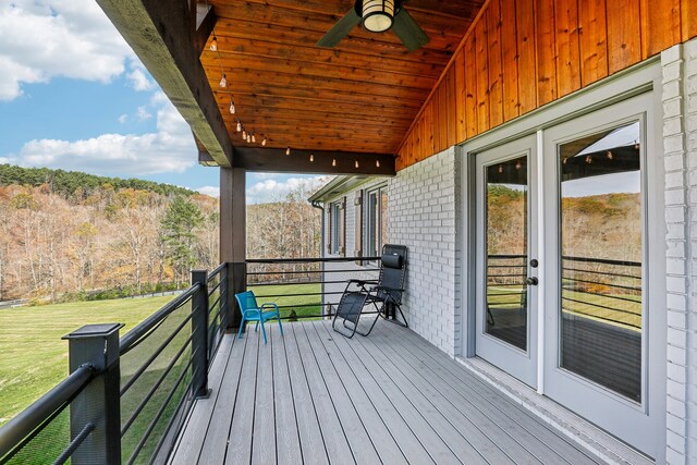 wooden deck with a lawn, ceiling fan, and french doors