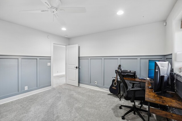 carpeted office featuring ceiling fan