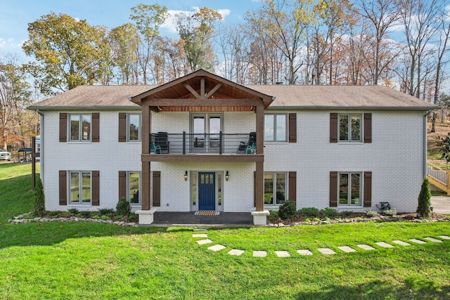 view of front of property featuring a balcony and a front lawn