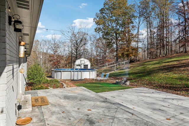 view of patio / terrace featuring a storage unit