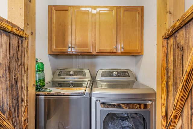 laundry area with cabinet space and independent washer and dryer