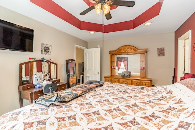 bedroom with a tray ceiling, a ceiling fan, and recessed lighting