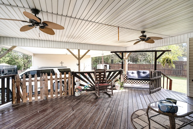 deck with a ceiling fan, a fenced backyard, and an outdoor hangout area