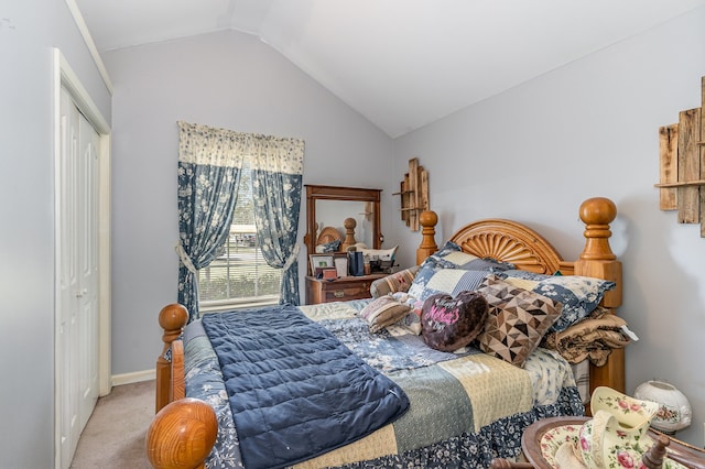 bedroom featuring lofted ceiling, a closet, light carpet, and baseboards