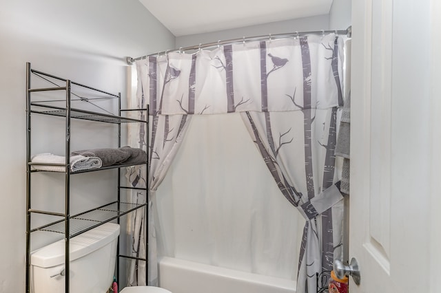 bathroom featuring shower / tub combo and toilet