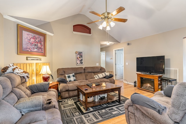 living room featuring a ceiling fan, visible vents, high vaulted ceiling, and light wood-style flooring