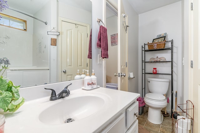 bathroom featuring tile patterned flooring, vanity, and toilet