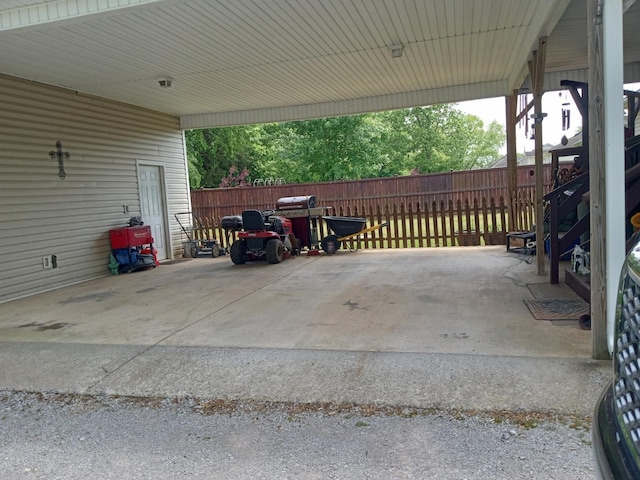 view of patio / terrace with an attached carport and fence