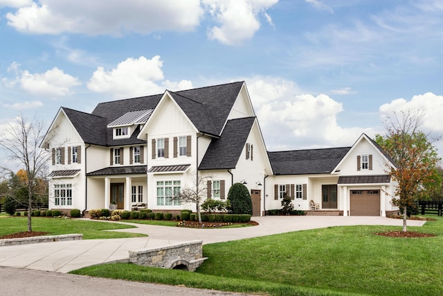 modern farmhouse featuring a garage and a front lawn