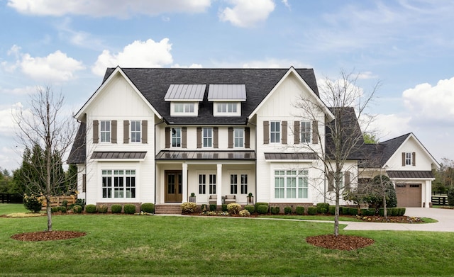 view of front of home featuring a garage, a front lawn, and covered porch